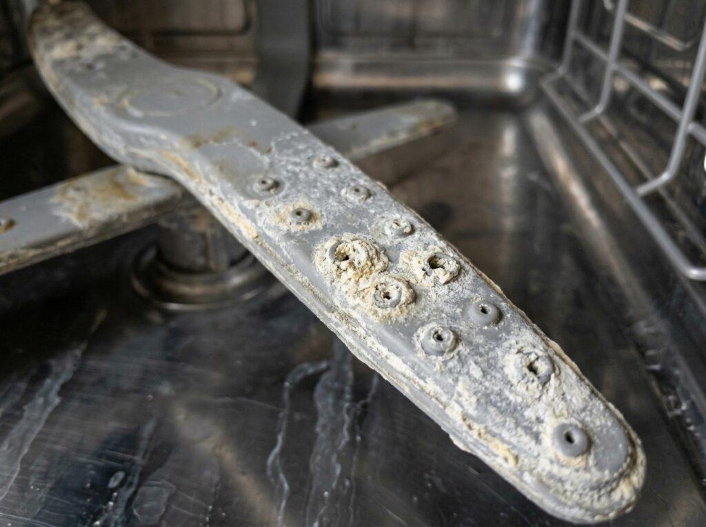 dishwasher spray arm with calcium buildup